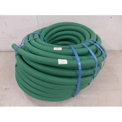 5308 - A large roll of green pipe