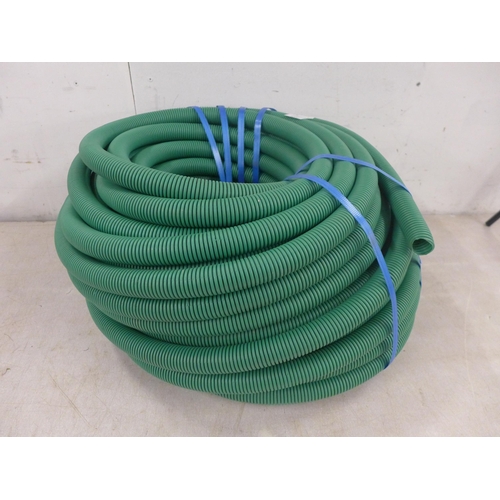 5308 - A large roll of green pipe