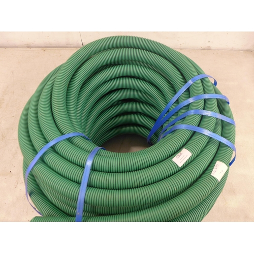 5308 - A large roll of green pipe