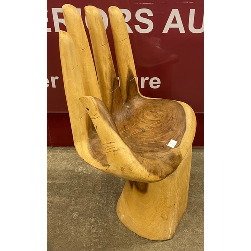 283 - A carved hardwood hand shaped chair