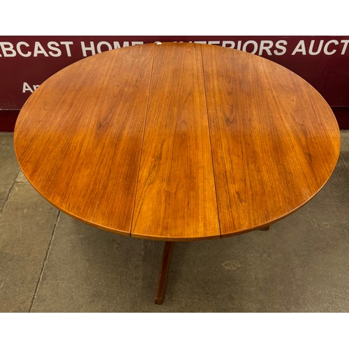 94A - A Danish teak circular drop leaf dining table