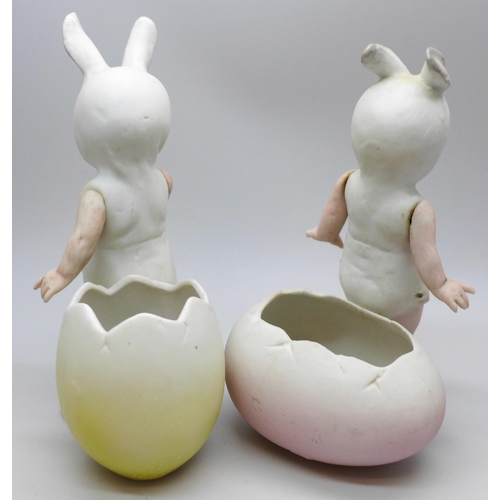 2037 - Gebruder Heubach, Germany, a of pair all bisque Easter bunny boy and girl figures with eggs and arti... 