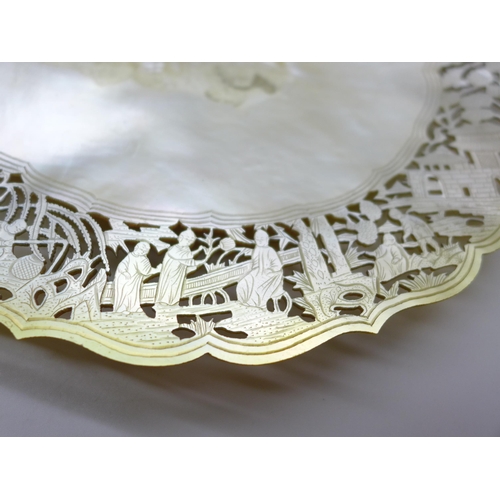 2047 - A mother of pearl shell shaped dish with fine cut decoration to the edge, 21cm, edge repaired