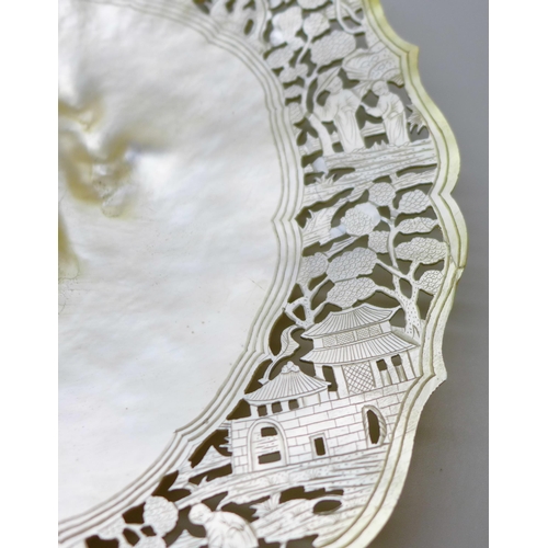 2047 - A mother of pearl shell shaped dish with fine cut decoration to the edge, 21cm, edge repaired