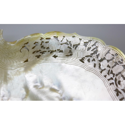 2047 - A mother of pearl shell shaped dish with fine cut decoration to the edge, 21cm, edge repaired