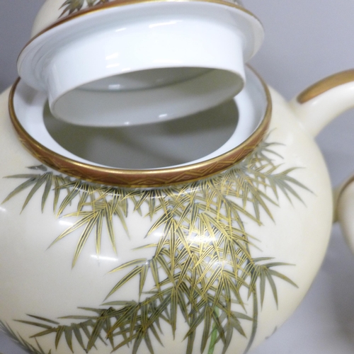 2110 - A Japanese eggshell porcelain tea set, with tea pot, cream and sugar, two cups, four saucers and tea... 