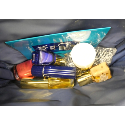 2174 - Four lady's Estee Lauder travel make-up bags, all complete with a range of unused contents, lipstick... 