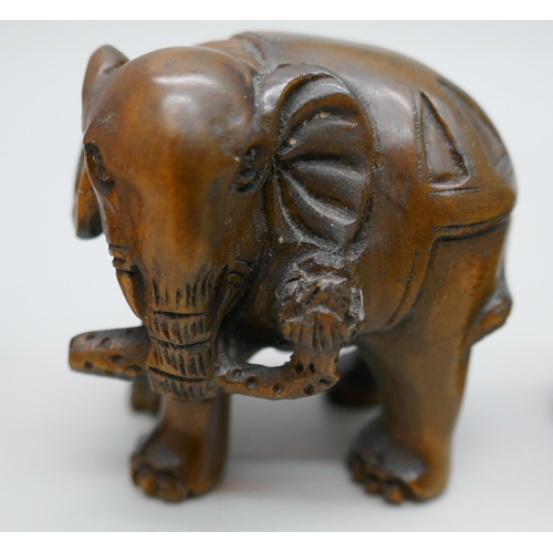 2256 - A collection of three carved boxwood netsuke figures, elephants