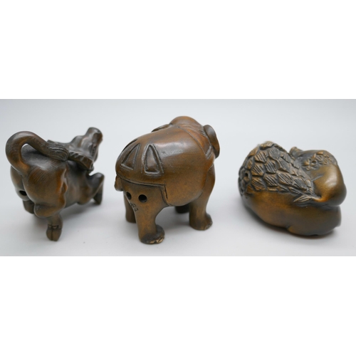 2256 - A collection of three carved boxwood netsuke figures, elephants