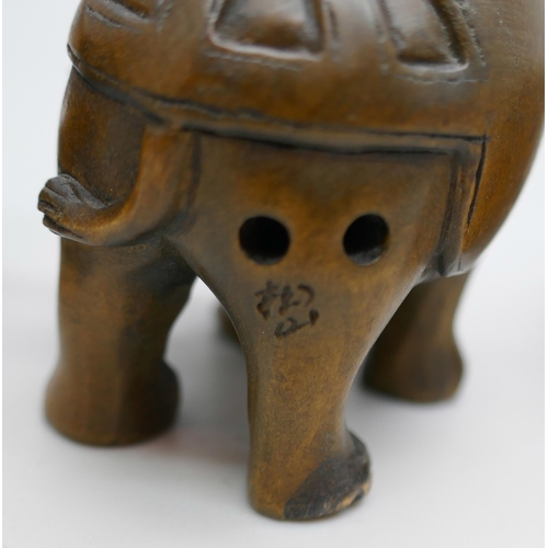 2256 - A collection of three carved boxwood netsuke figures, elephants