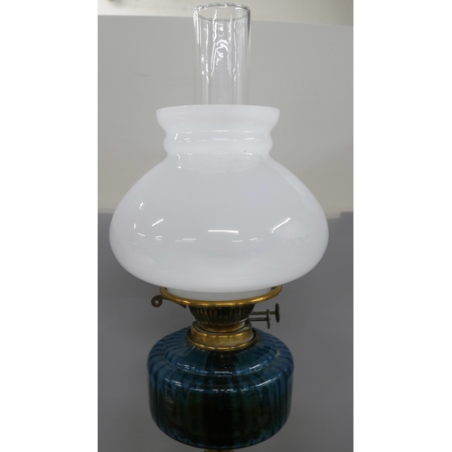 2291 - A brass oil lamp with blue glass reservoir **PLEASE NOTE THIS LOT IS NOT ELIGIBLE FOR IN-HOUSE POSTI... 