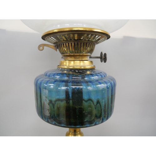 2291 - A brass oil lamp with blue glass reservoir **PLEASE NOTE THIS LOT IS NOT ELIGIBLE FOR IN-HOUSE POSTI... 