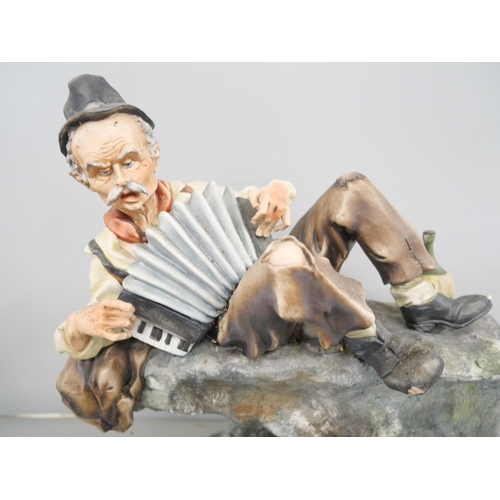 2306 - A Capodimonte figure of an accordion player