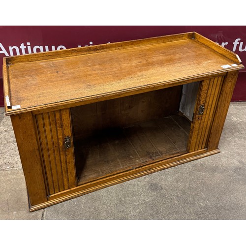 196A - An early 20th Century oak tambour front cabinet