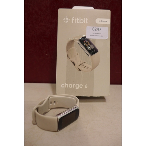 6247 - Fitbit Charge 6 activity tracker with beige wristband *This lot is subject to VAT