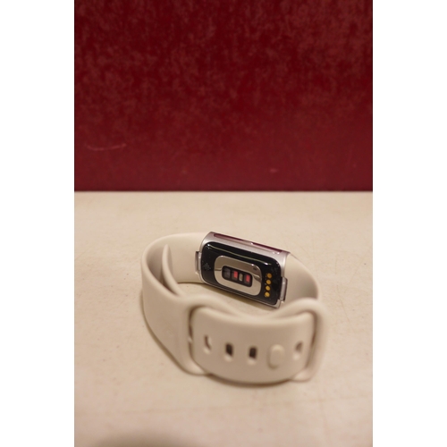 6247 - Fitbit Charge 6 activity tracker with beige wristband *This lot is subject to VAT