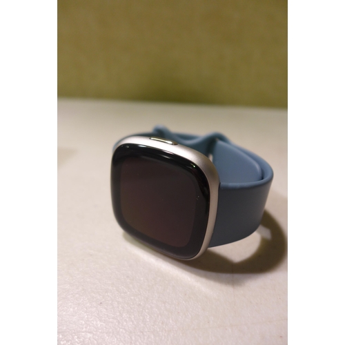 6292 - Fitbit Versa 4 fitness smartwatch with blue infinity band, model no: FB523 *This lot is subject to V... 