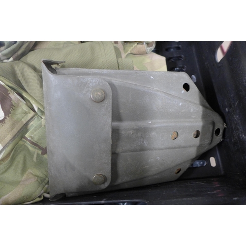 5213 - A vintage Karrimore framed back pack, two unused camouflaged shirts, a folding trenching spade and a... 