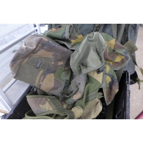 5213 - A vintage Karrimore framed back pack, two unused camouflaged shirts, a folding trenching spade and a... 