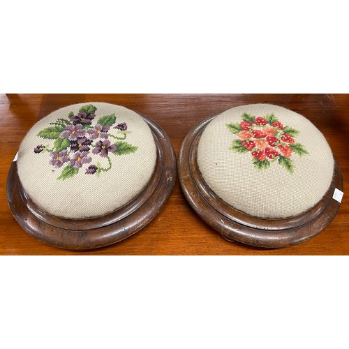 202A - A pair of Victorian walnut and embroidered footstools