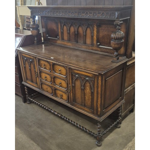 216 - An early 20th Century Jacobean Revival carved oak sideboard