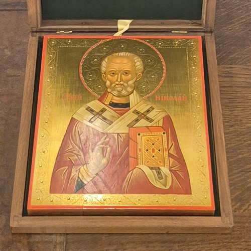 402 - A Russian painted wooden Icon, in presentation case, with plaque verso dated 1975