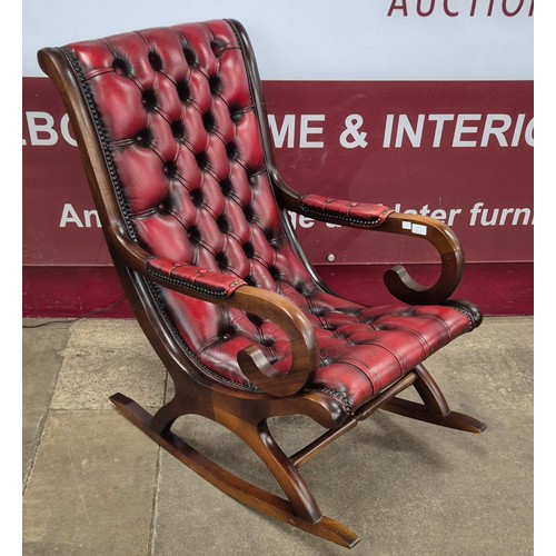 4 - A mahogany and oxblood leather rocking chair