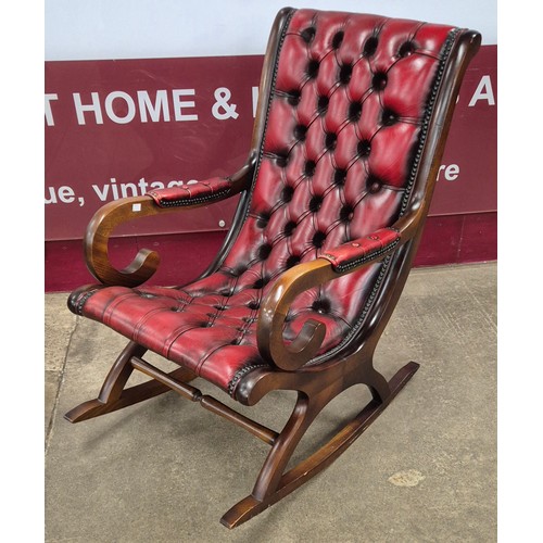 4 - A mahogany and oxblood leather rocking chair