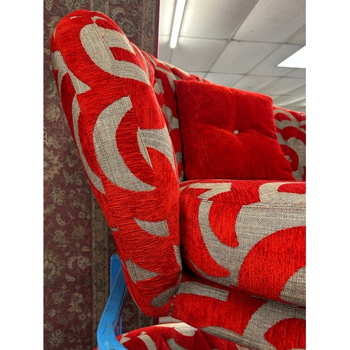 3067 - A red and grey patterned three seater sofa