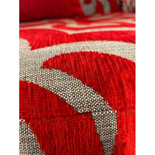 3067 - A red and grey patterned three seater sofa