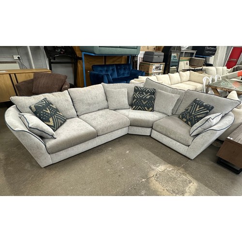 3074 - A stone grey upholstered three piece corner sofa with blue piping