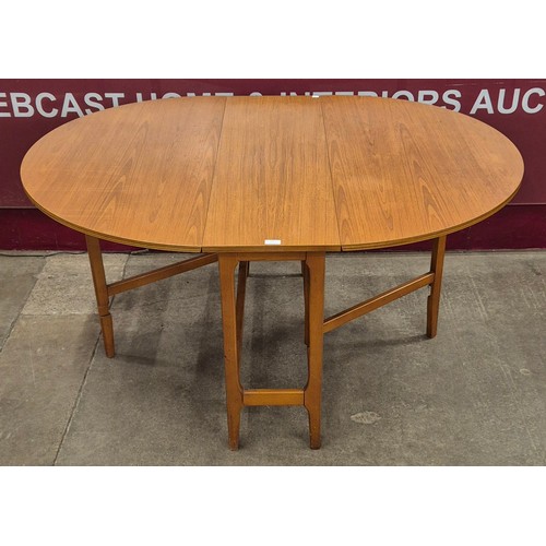 51 - A teak drop leaf table and four chairs