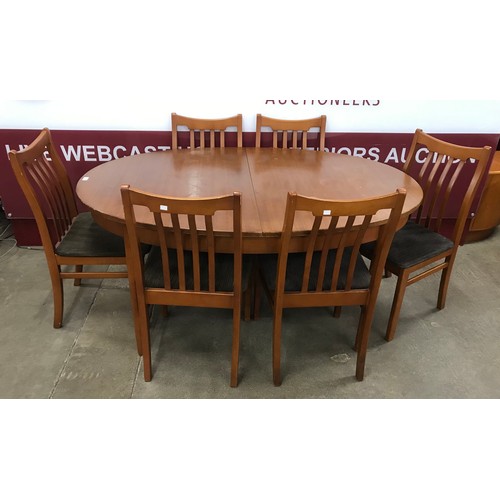 40 - A teak oval extending dining table and six chairs