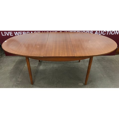 40 - A teak oval extending dining table and six chairs