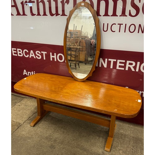 65 - A teak coffee table and a teak framed mirror