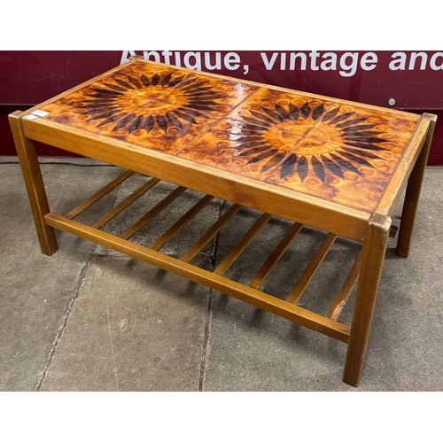 83 - A teak and tiled top coffee table