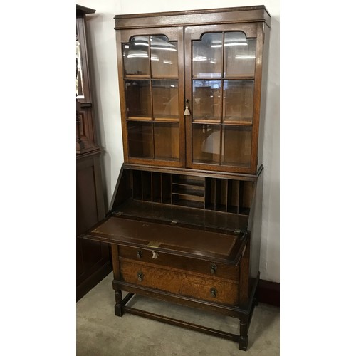 150 - An early 20th century oak bureau bookcase