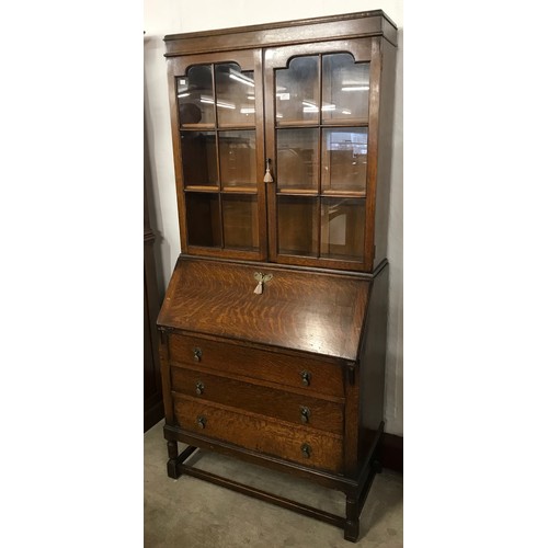 150 - An early 20th century oak bureau bookcase