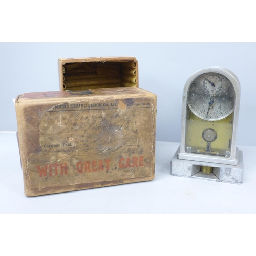 2022 - A small pigeon clock, McMillan’s Patent automatic timing clock, with original postage box, 12cm