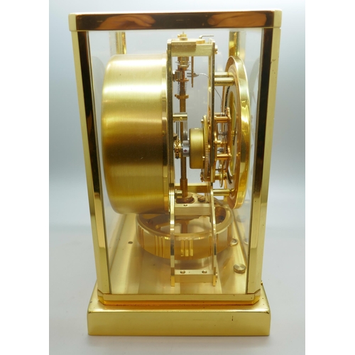 2172 - A Jaeger-LeCoultre Atmos clock, with fitted case, with Garrard & Co. guarantee dated 1976, also with... 