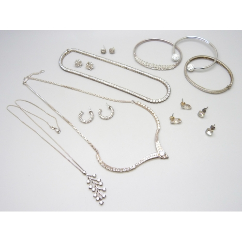 7069 - A collection of silver jewellery including a tennis necklace, another silver stone set necklace, thr... 