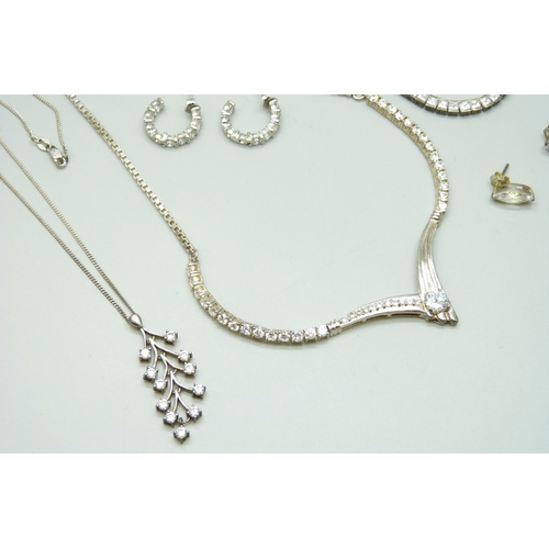 7069 - A collection of silver jewellery including a tennis necklace, another silver stone set necklace, thr... 