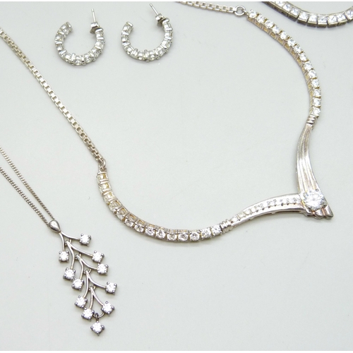 7069 - A collection of silver jewellery including a tennis necklace, another silver stone set necklace, thr... 