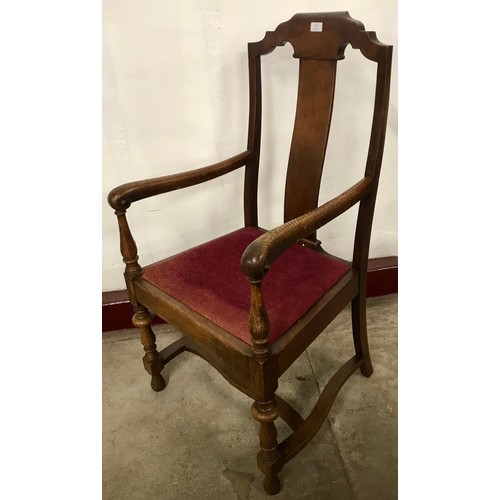 241 - An early 20th Century elm and oak elbow chair