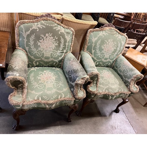 261 - A pair of early 20th Century Queen Anne style carved walnut and fabric upholstered armchairs