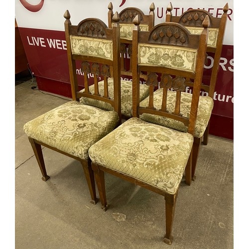 122 - A set of four Art Nouveau carved oak dining chairs