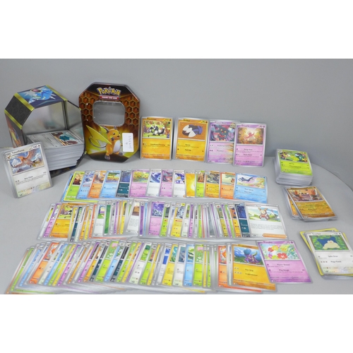 2106 - A large collection of Pokemon cards with holographic, in collectors tin