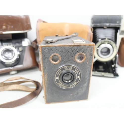 2150 - Three cameras, comprising of Box Brownie Junior, Kodak Concertina camera and a Regula Sprinty. All c... 