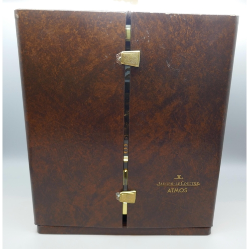 2172 - A Jaeger-LeCoultre Atmos clock, with fitted case, with Garrard & Co. guarantee dated 1976, also with... 