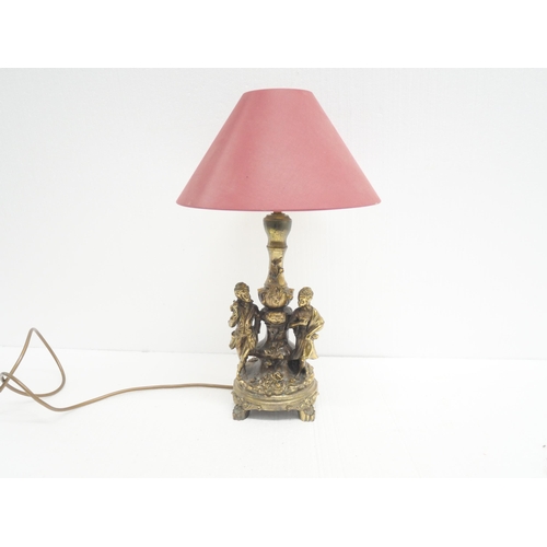 2283 - A gilt decorative figural table lamp depicting couple among floral decoration. Lamp shade included.